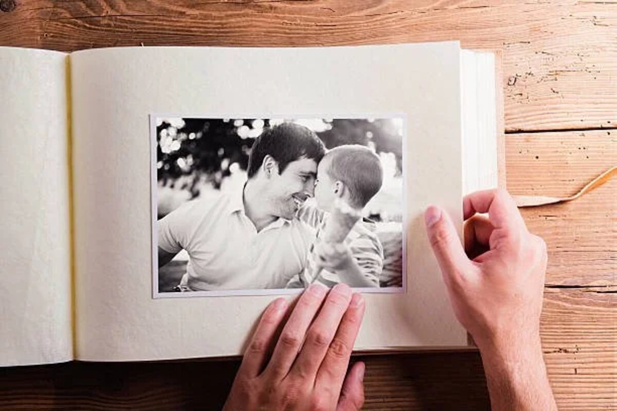 Hands turning the page of a family photo album